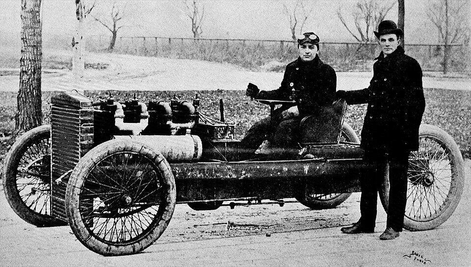 Henry Ford: The first moving assembly line 3 Ford (standing) launched Barney Oldfield's career in 1902.
