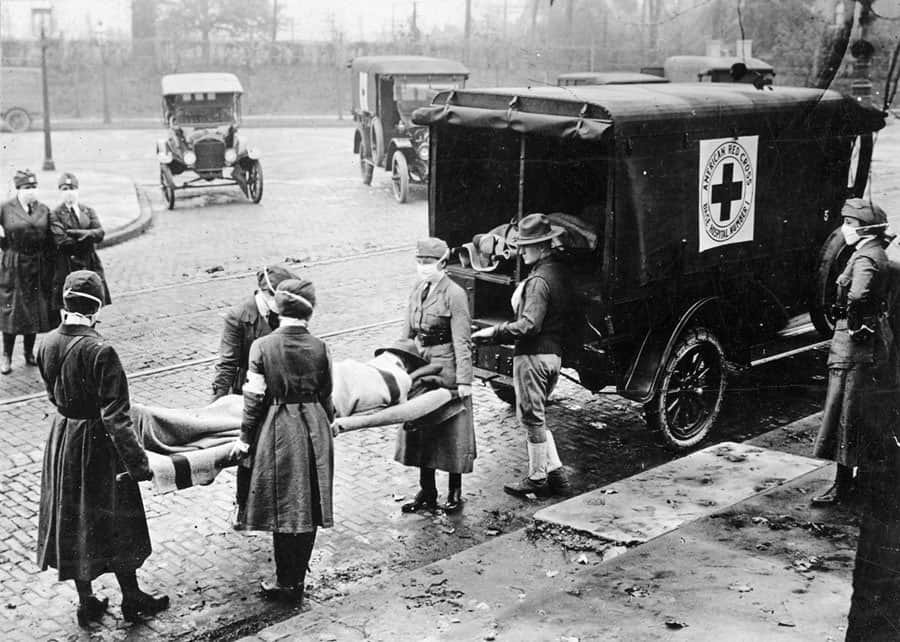 American Red Cross workers carry a body during the 1918–20 "Spanish flu" pandemic.